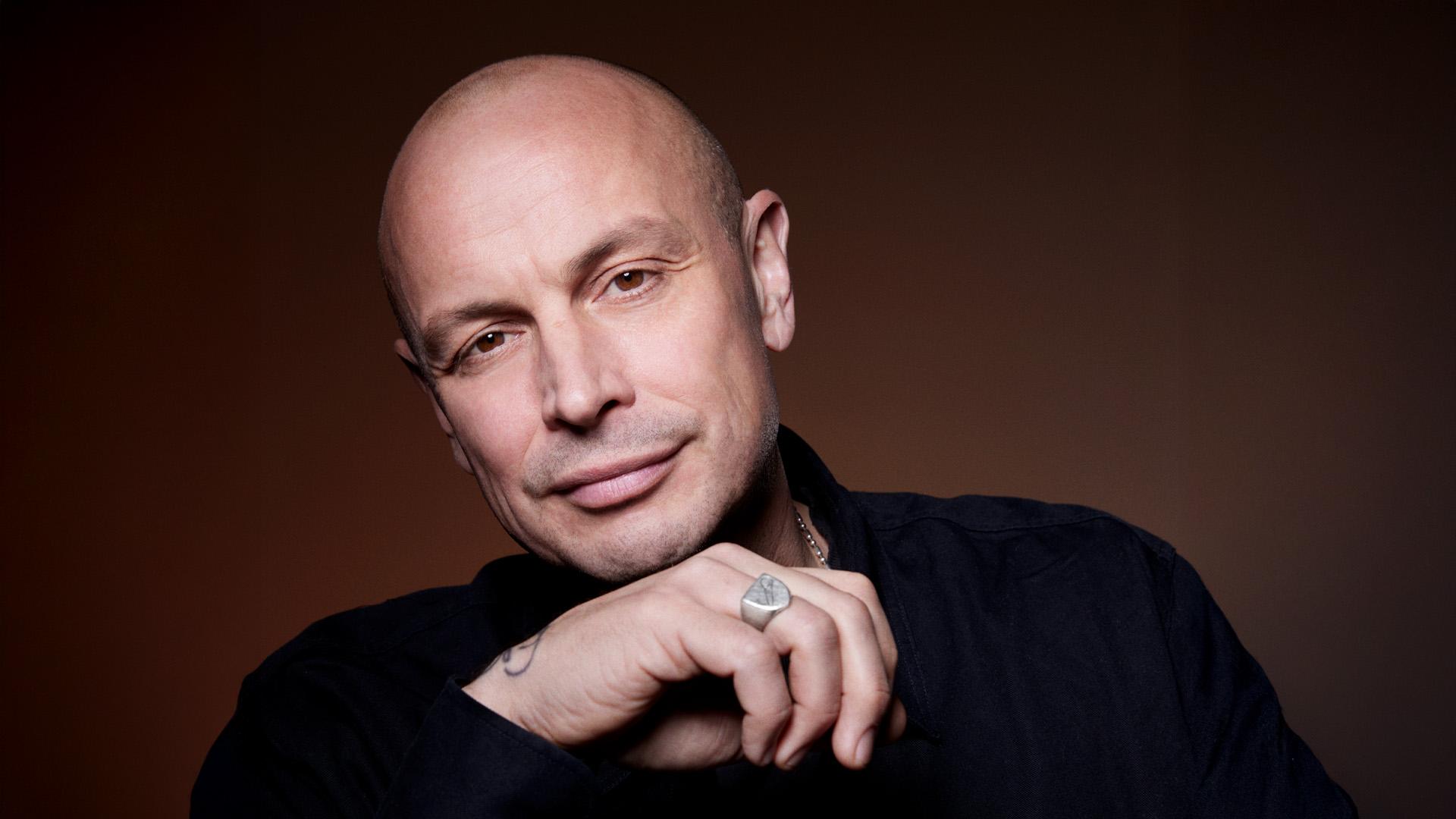 Artisten Petter. Hans hand har en klackring, han bär en mörk tröja och en halskedja.